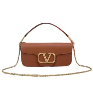 Front view of a luxurious smooth leather Valentino Garavani shoulder bag with a prominent gold VLogo signature and a fine gold chain strap.