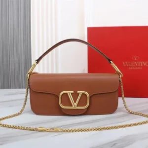 Front view of a luxurious smooth leather Valentino Garavani shoulder bag with a prominent gold VLogo signature and a fine gold chain strap.
