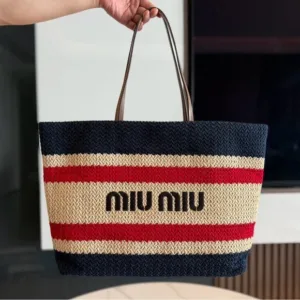 Close-up of Miu Miu woven tote bag with decorative stripes and structured shape.