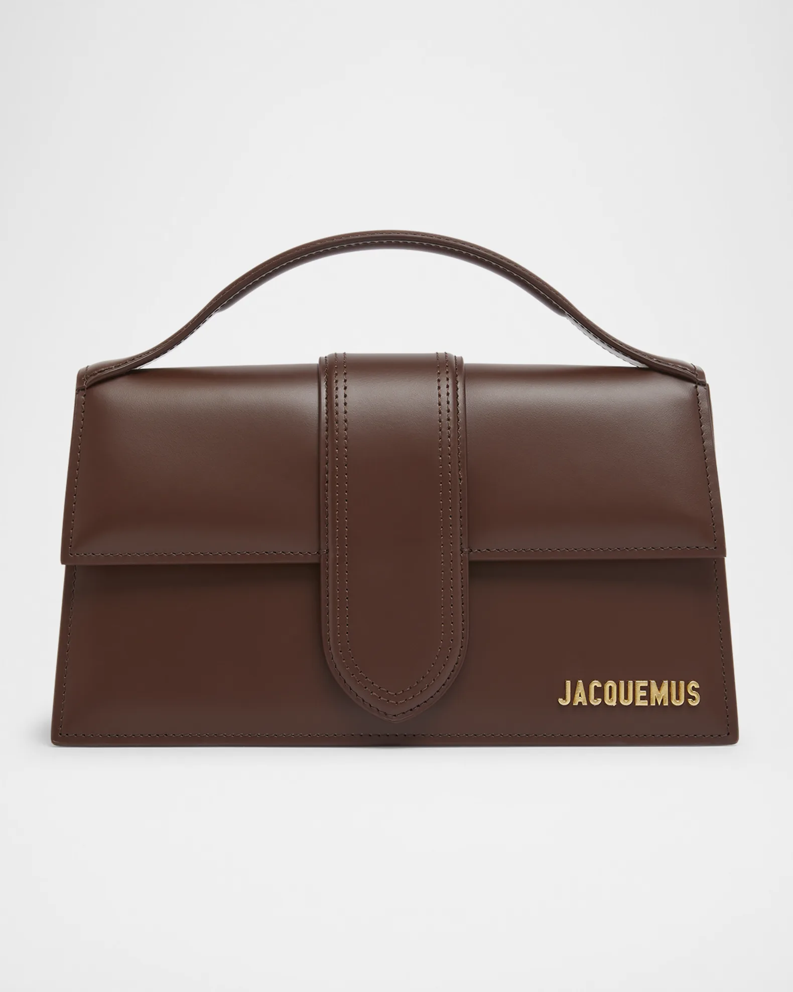 Luxury brown Jacquemus Bag Details Close-up of Jacquemus handbag stitching and gold branding.