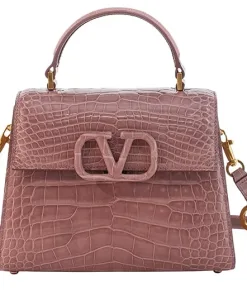 Close-up shot of the textured exotic leather on the Valentino top handle bag, highlighting the structured design and flap closure.