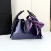 Open view of the interior compartment of the purple velvet bucket bag showing storage space.