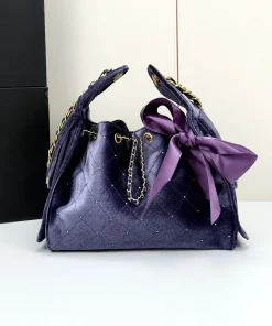 Open view of the interior compartment of the purple velvet bucket bag showing storage space.