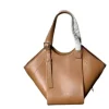 Side view of light brown Hammock Flip bag showing adjustable shoulder strap and soft leather texture.