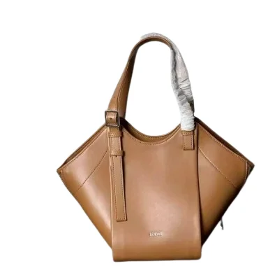 Side view of light brown Hammock Flip bag showing adjustable shoulder strap and soft leather texture.