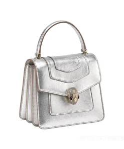 side view of BVLGARI Serpenti Forever handbag showing back pocket, interior pocket, and vanity mirror