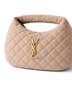 Side profile of Saint Laurent Icarino Baby quilted suede bag showing crescent shape and handle drop