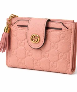 Blush pink leather wallet with embossed pattern and gold logo