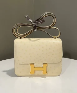 Open Hermès Constance 18 bag showing lambskin-lined interior and pockets