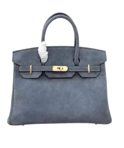 Gold turnlock hardware on Hermès Birkin 25 in slate blue leather, showing minor hairline scratches