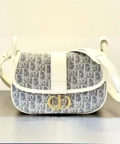 Model wearing the Dior Bobby East-West Bag on shoulder, highlighting the compact size and elegant design