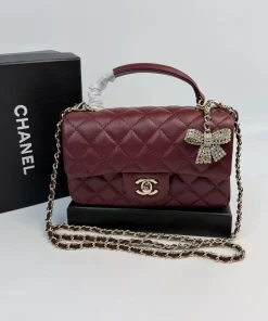 Burgundy Chanel mini quilted leather flap bag with top handle and chain strap