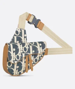 Beige and black patterned saddle style crossbody bag with leather trim