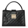 Front view of Gucci Padlock Medium Top Handle Bag made from embossed GG leather with gold hardware