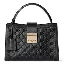 Front view of Gucci Padlock Medium Top Handle Bag made from embossed GG leather with gold hardware