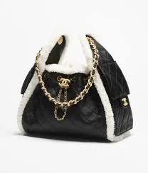 Black leather Chanel hobo handbag with white shearling sides and gold chain