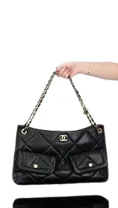 Close-up of Chanel Maxi Hobo Bag featuring black quilted leather and gold-tone metal accents