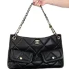 Close-up of Chanel Maxi Hobo Bag featuring black quilted leather and gold-tone metal accents
