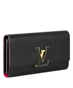 side view of Louis Vuitton Capucines Wallet showing black cowhide leather