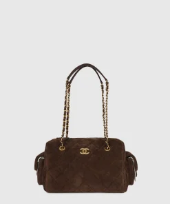 Chanel small bowling bag in dark brown suede with quilted design and antique gold hardware
