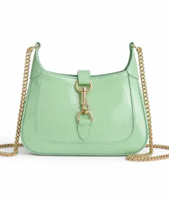 Gucci Jackie Notte mini patent leather shoulder bag with chain strap and hobo shape in light green.