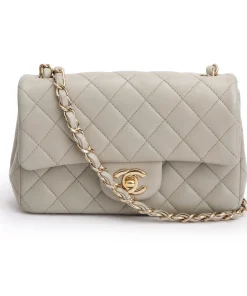 Front view of a light grey Chanel Classic Flap Bag in black quilted leather with gold-tone hardware
