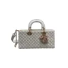 White Dior handbag featuring Cannage pattern with pearl detailing and strap