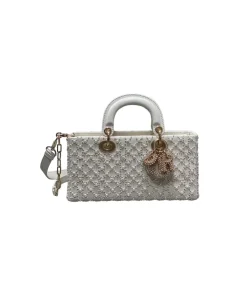 White Dior handbag featuring Cannage pattern with pearl detailing and strap