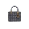 Christian Dior Mini Lady Dior crystal bag showing gold chain strap, suede interior, and refined luxury detailing