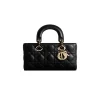 Black Christian Dior Lady D-Joy designer handbag with structured silhouette and signature charm