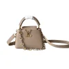 Beige Louis Vuitton Capucines mini leather handbag with top handle and gold logo
