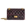 Chanel mini reissue 2.55 bag worn as crossbody with elegant gold hardware