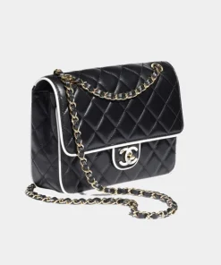 Front view of Chanel Classic Mini Flap Bag crafted in black lambskin with white trim
