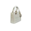 White designer Dior bag with crystal studs and top handle