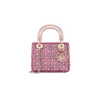 Elegant woman carrying Mini Lady Dior Bag at a formal event