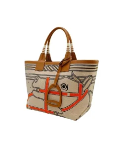 Side view of Hermès Steeple 25 horse print tote bag in ecru, noir, and gold tones with structured base