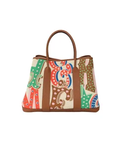 Colorful Hermès Garden Party 36 tote bag in capucine, ecru, and gold canvas with leather trim and structured base