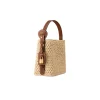 Model carrying brown raffia All In BB handbag with adjustable strap for casual city and travel use