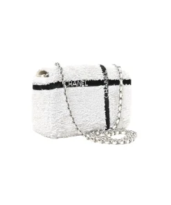 Luxury Chanel mini flap handbag in white and black sequins with silver turnlock and chain strap