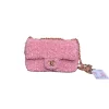 Elegant pink sequined Chanel flap bag with sparkling texture and luxury design for stylish occasions