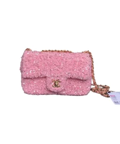 Elegant pink sequined Chanel flap bag with sparkling texture and luxury design for stylish occasions