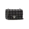 Black and silver Chanel 2025C small flap bag with crystal detailing and chain strap for shoulder wear
