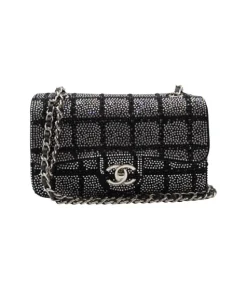Black and silver Chanel 2025C small flap bag with crystal detailing and chain strap for shoulder wear