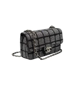 Luxury Chanel black and silver strass crystal flap bag worn as crossbody with elegant chain strap