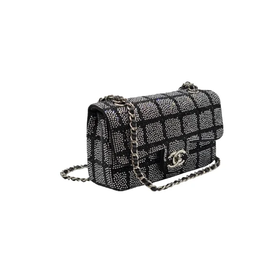 Luxury Chanel black and silver strass crystal flap bag worn as crossbody with elegant chain strap