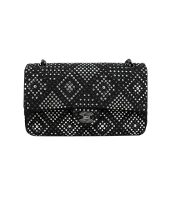 Luxury Chanel tweed classic flap bag with crystal embellishment worn on shoulder