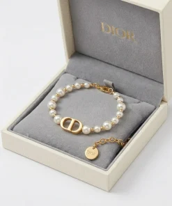 Gold Christian Dior 30 Montaigne bracelet with white resin pearls and CD charm