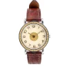 Close-up of vintage Hermès Sellier wristwatch showing gold-tone case and orange brown leather strap design