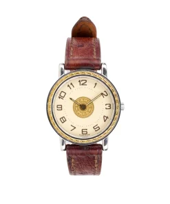 Close-up of vintage Hermès Sellier wristwatch showing gold-tone case and orange brown leather strap design
