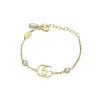 Elegant gold-tone Gucci GG Marmont bracelet featuring Double G charm and white pearl embellishments for women